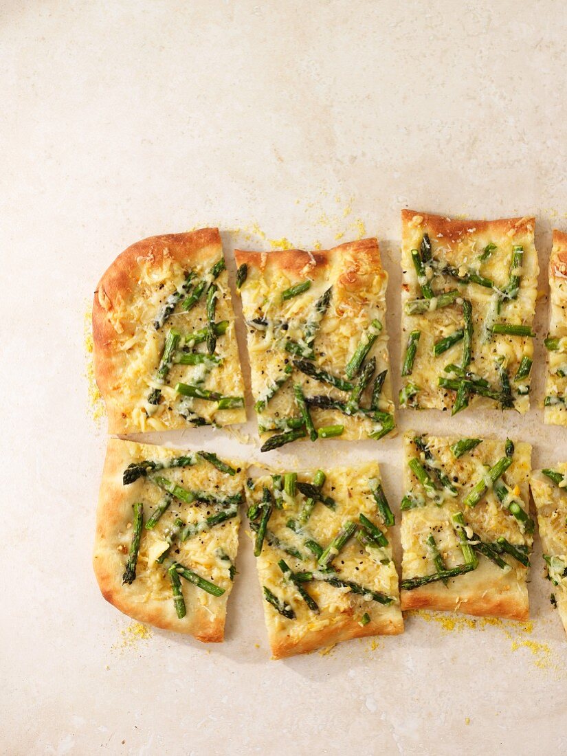 Asparagus pizza cut into slices
