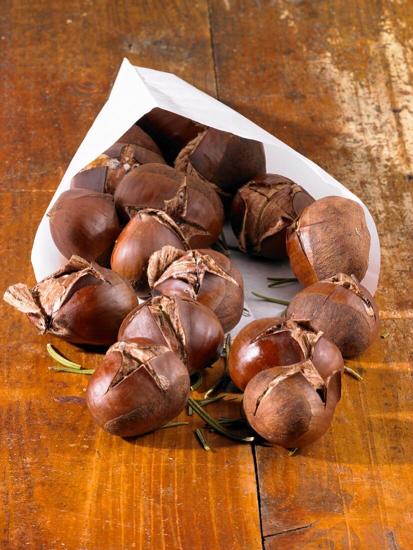 Chestnuts with rosemary in a paper bag