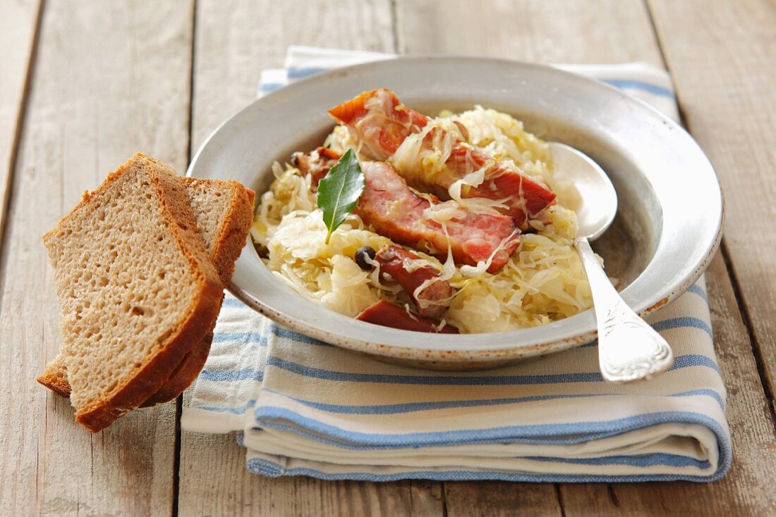 A meat platter with sauerkraut and bread