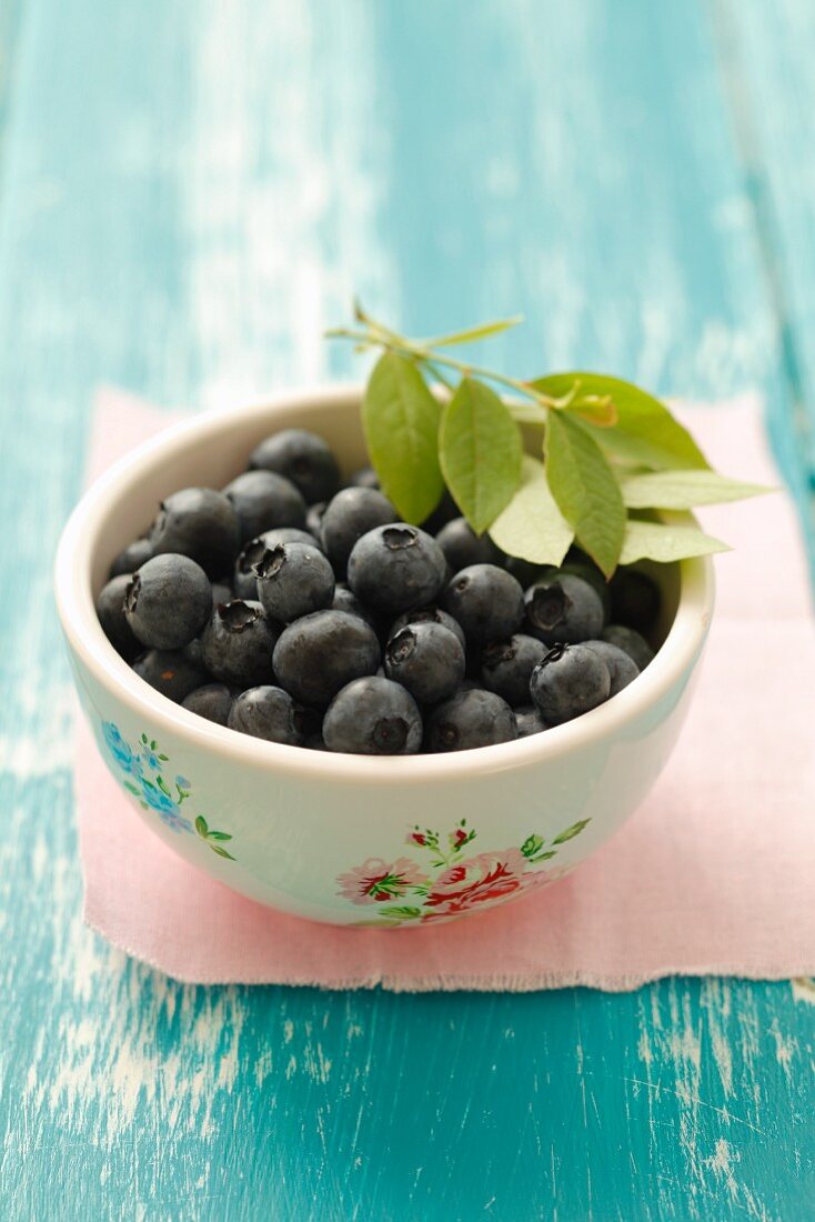 Blueberries and leaves in a bowl
