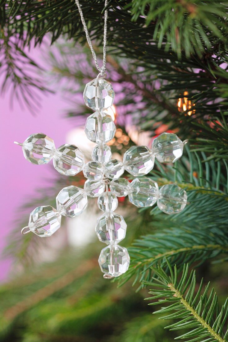 A star made of glass beads hanging on the Christmas tree