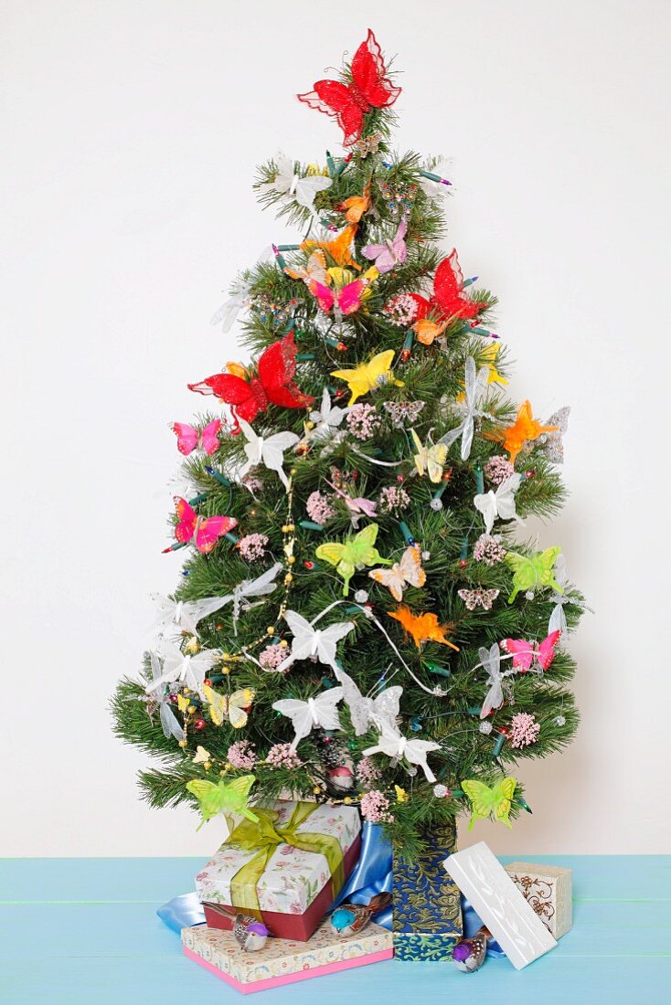 A Christmas tree decorated with butterflies and presents