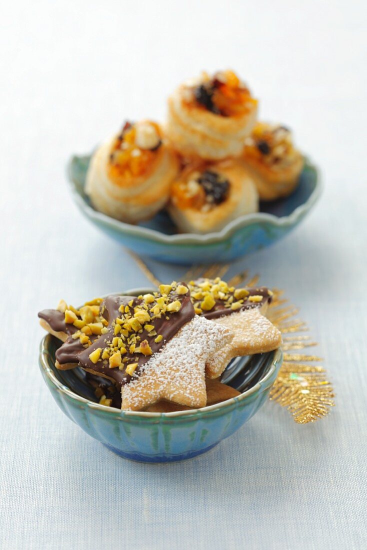 Star shaped biscuits decorated with chocolate and pistachios and vol au vents filled with mincemeat