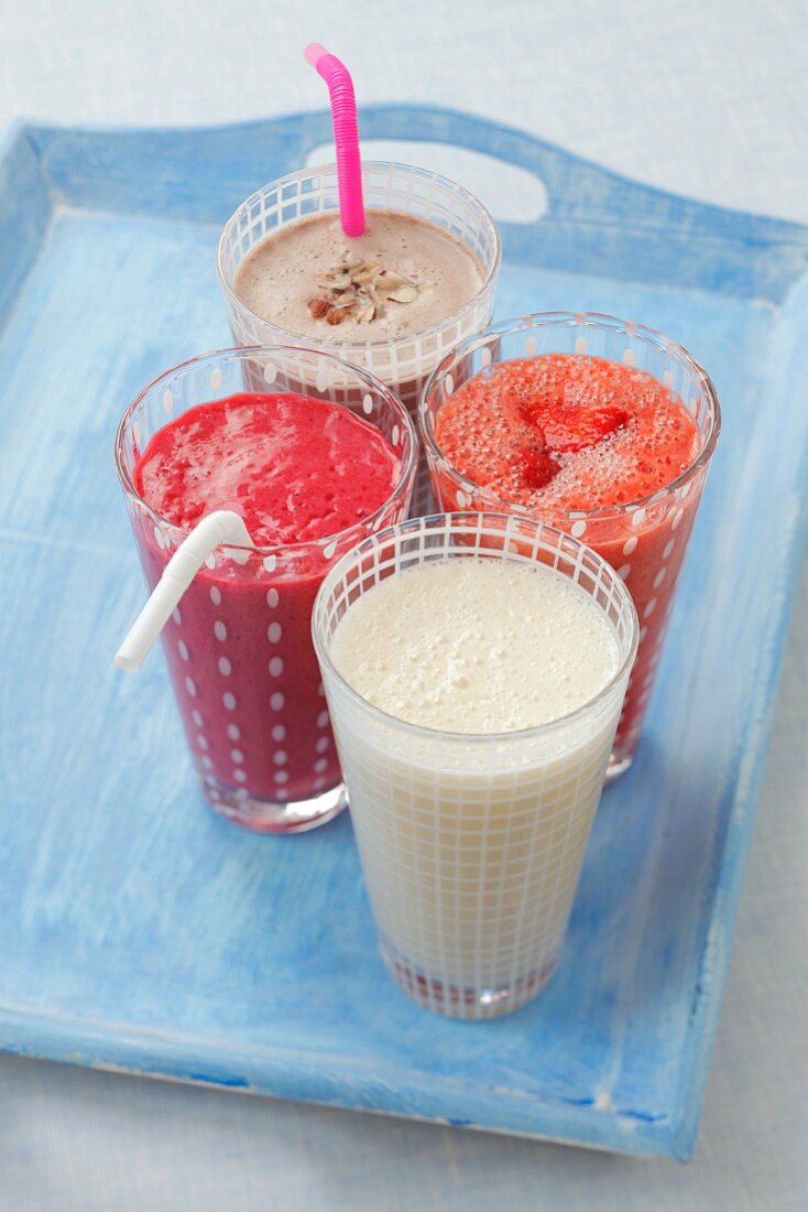 Four milkshakes (banana, chocolate, strawberry, raspberry)