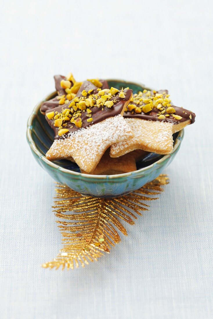 Star-shaped biscuits decorated with chocolate and pistachios