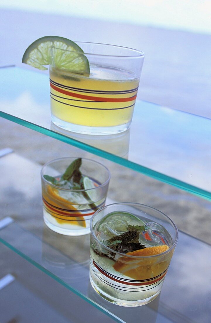 Three drinks with lime and lemons