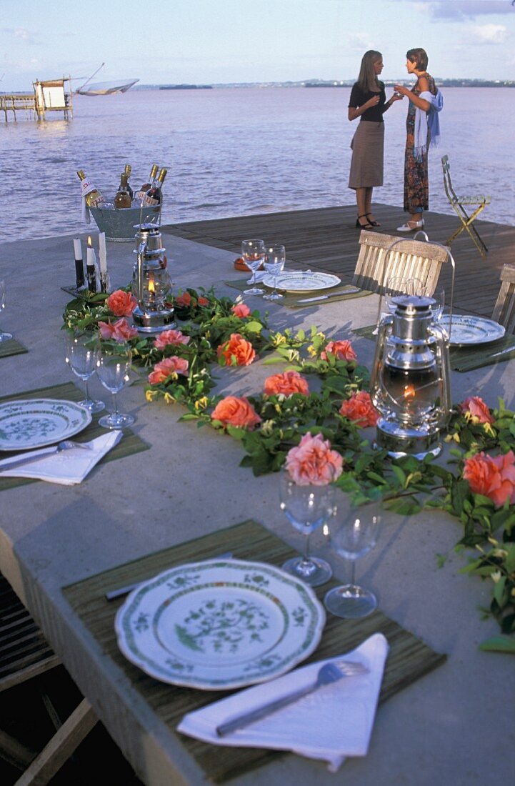 A festively laid table by the sea