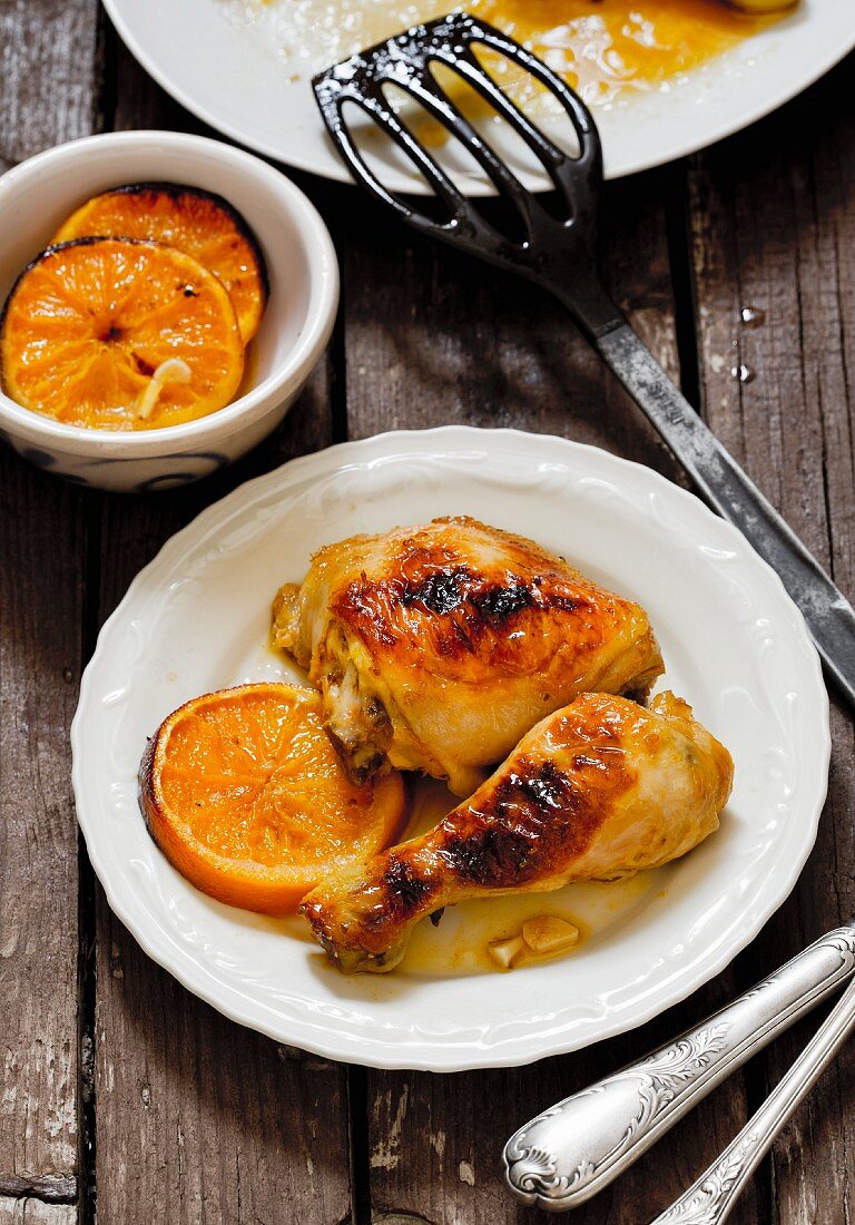 Chicken leg with oranges