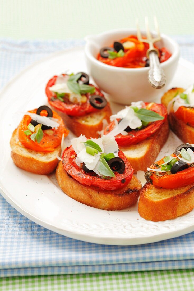 Crostini (toasted bread topped with tomatoes, Parmesan cheese and olives)