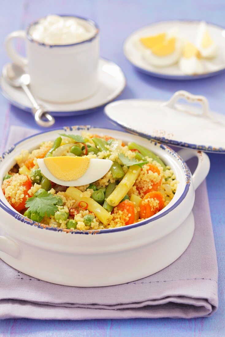 Couscous salad with green and yellow beans, eggs and dried apricots