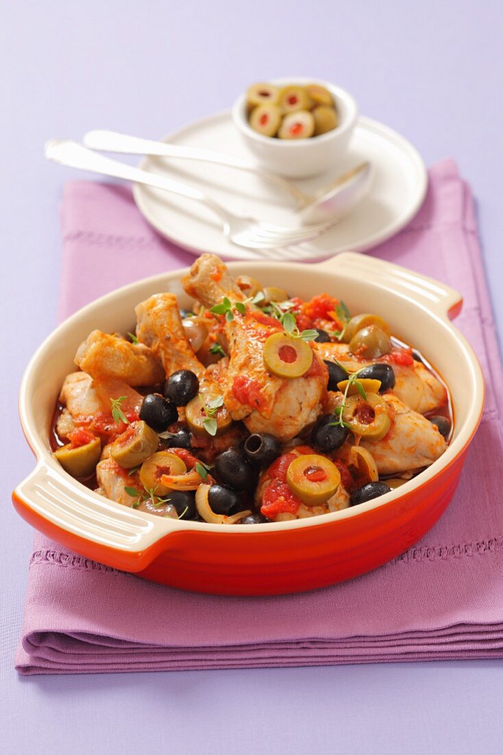 Braised chicken legs with olives and tomatoes