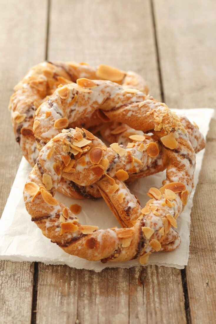 Danish pastry style pretzels with slivered almonds and icing
