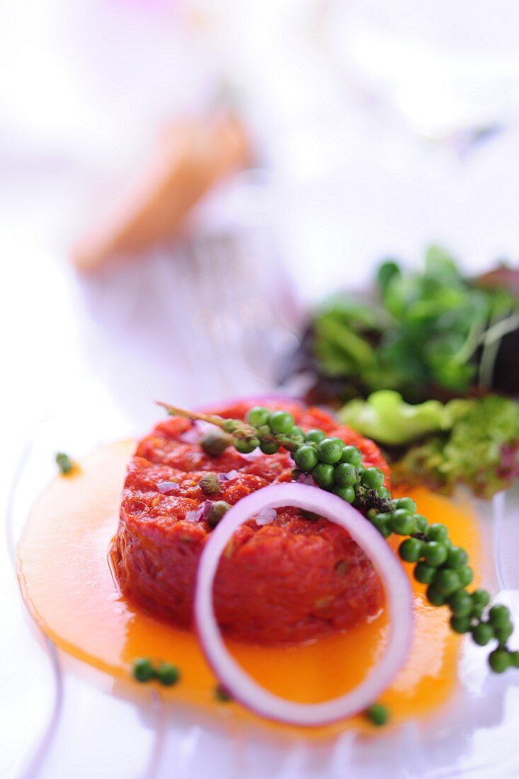 Steak tartare with egg, onion and green pepper