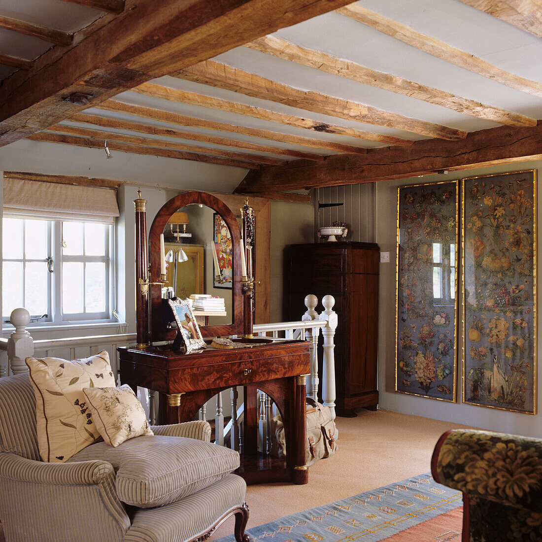 Country-style living room with wooden beamed ceiling and antique table with mirror