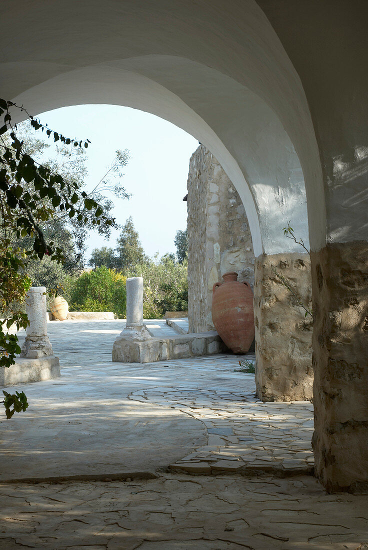 Shady arcade outside stone house (Tunisia)