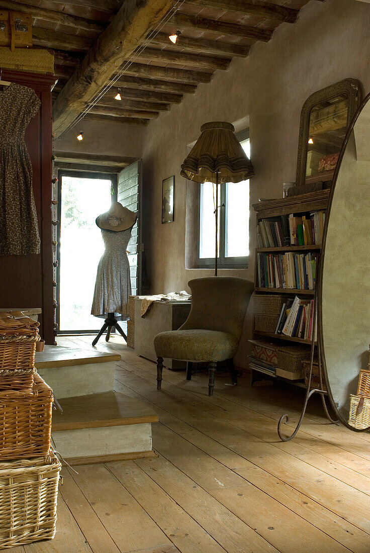 Country-style hallway with wooden floor, dressmaker's dummy and antique furniture