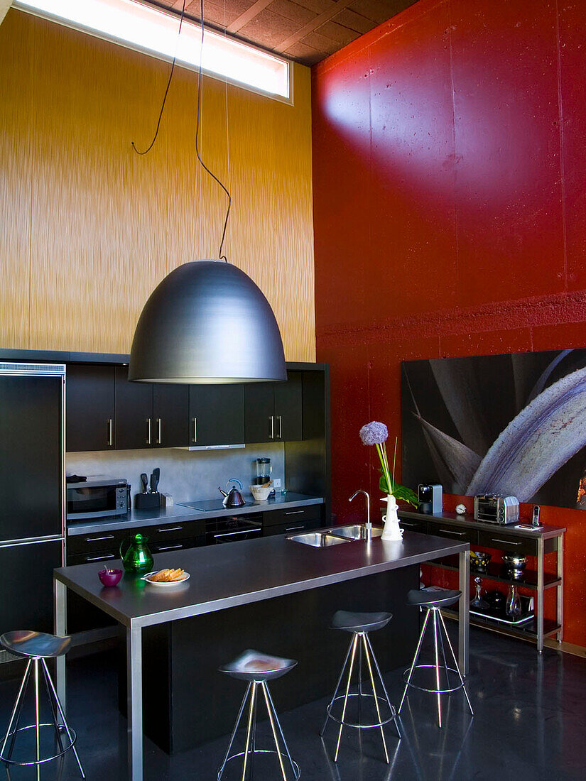 Modern kitchen with industrial lighting and contrasting colors