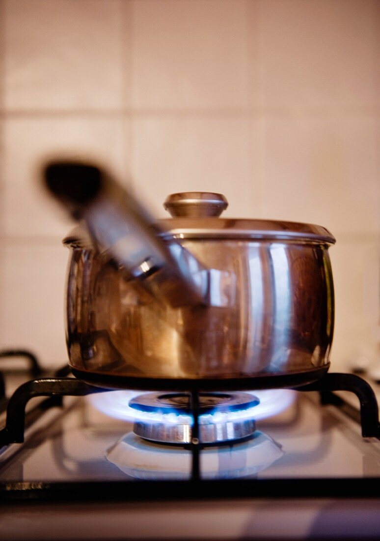 A cooper pot on a gas hob