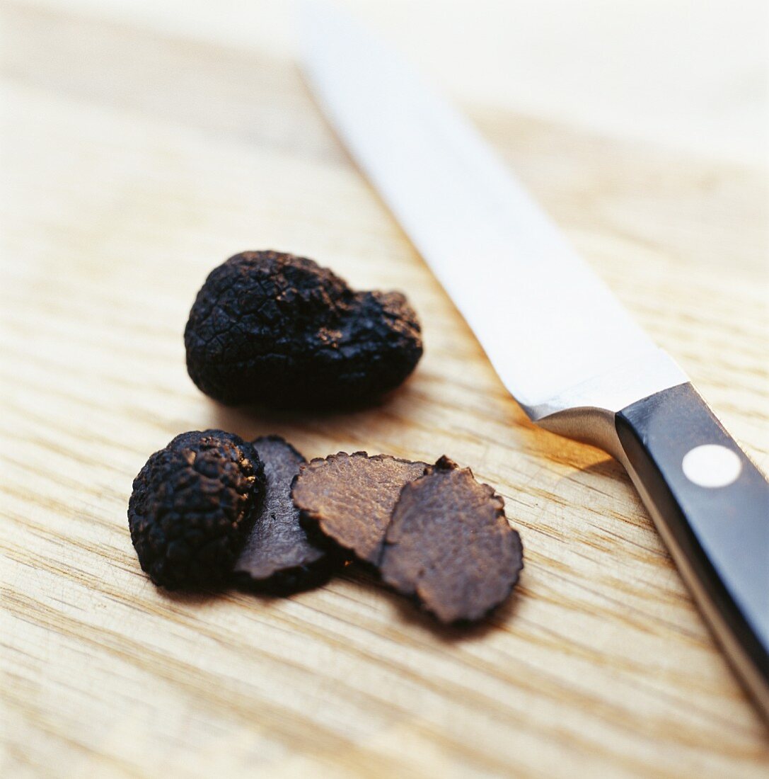 Black truffles with a knife
