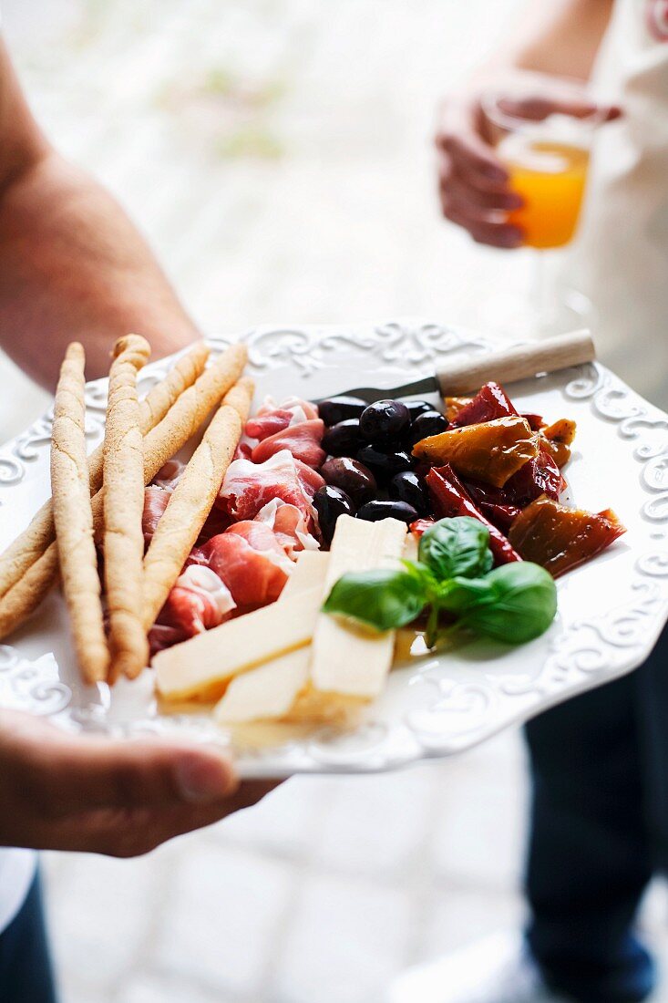 An antipasti platter with grissini
