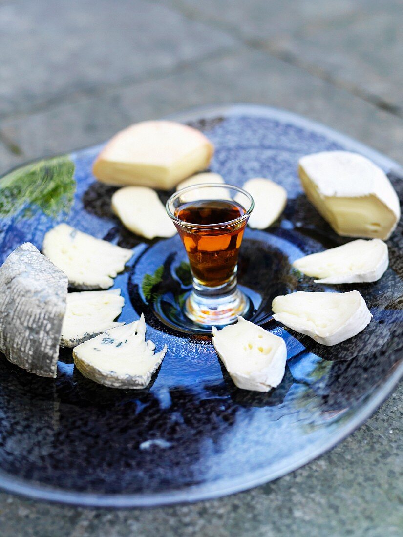 A cheese platter with a glass of sherry