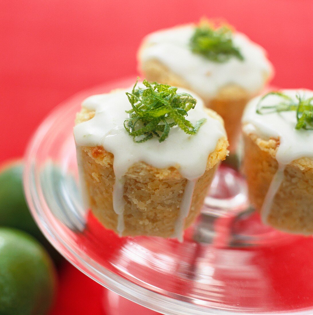 Almond cakes with icing and lime zest