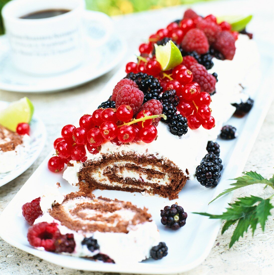 A Swiss roll with cream and berries