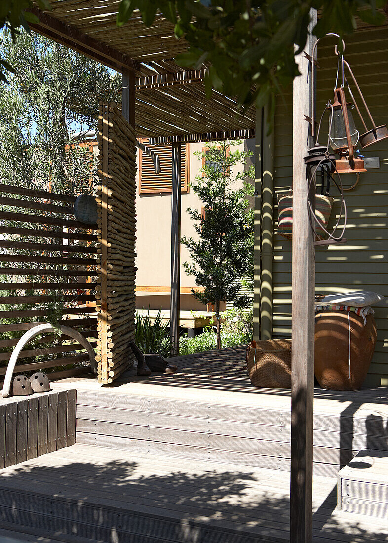 Terrace with wooden floor and pergola, lanterns