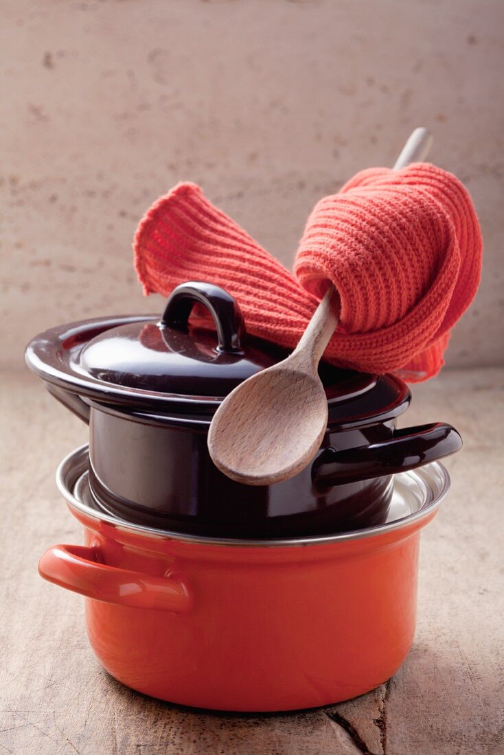 Pots, a wooden spoon and pot holders