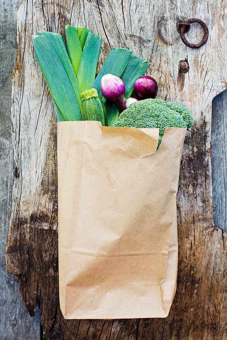 A paper bag of fresh vegetables