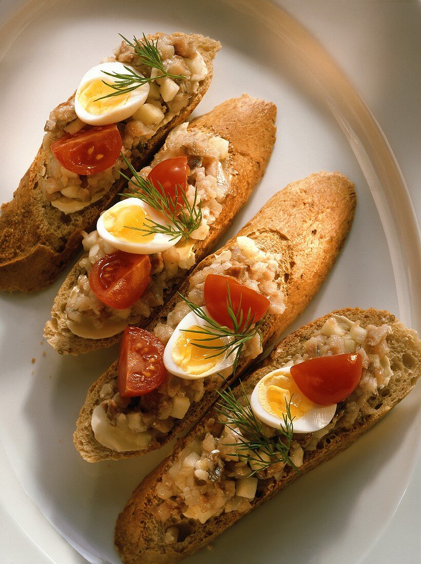Maatjes Herring on Bread Slices with Mayonnaise, Egg and Tomato