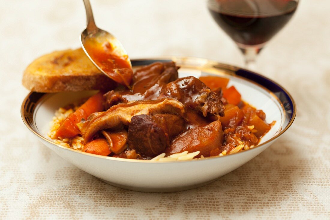 Bowl of Hearty Lamb Stew with Spoon and Bread