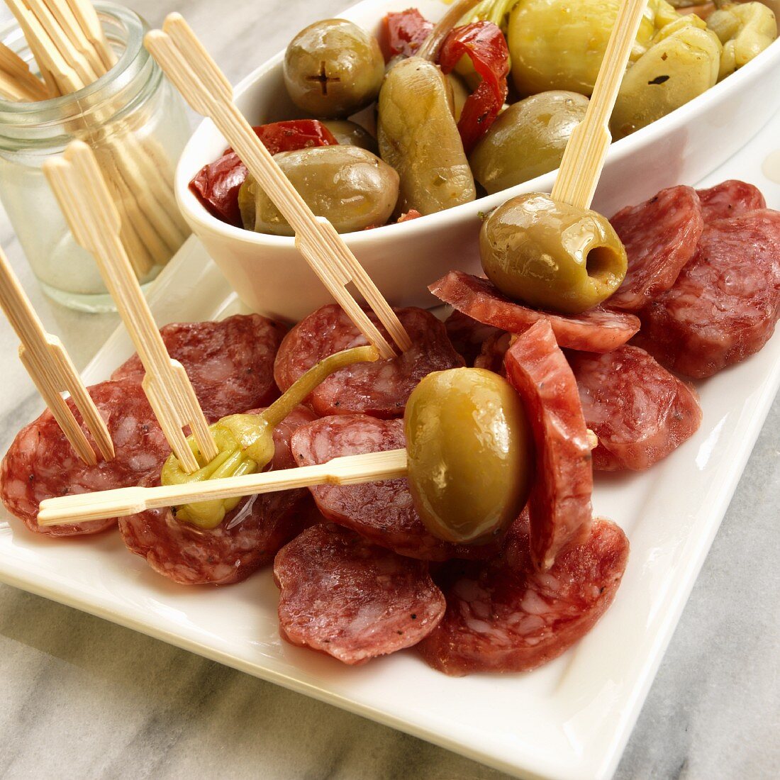 Fuet Salami Slices with Green Olives and Peppers; With Wooden Toothpicks