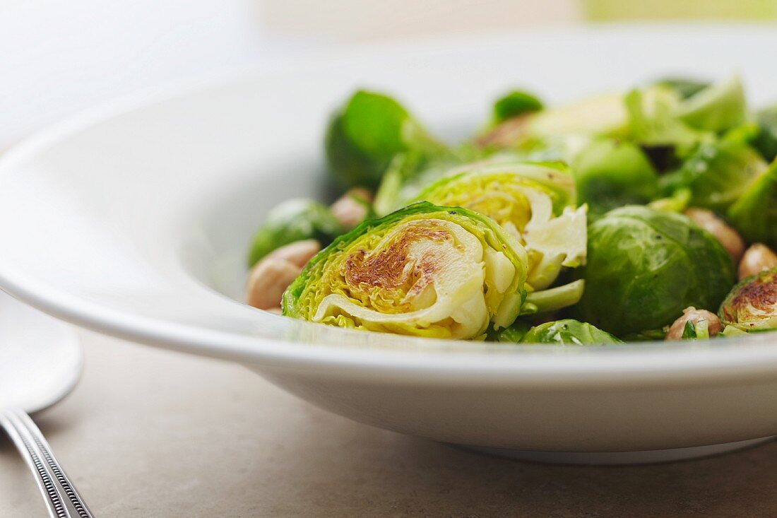 Serving Bowl of Sauteed Brussels Sprouts with Macadamia Nuts
