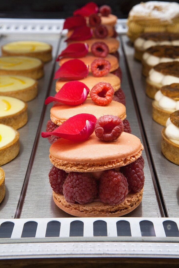 Ispahan Macaroon with Rose Butter Cream, Fresh Raspberry and Lychee; In a Bakery Display Case