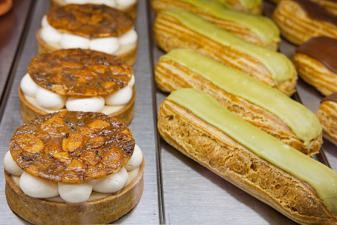 Darjeeling Tarts and Eclairs in a Bakery Case