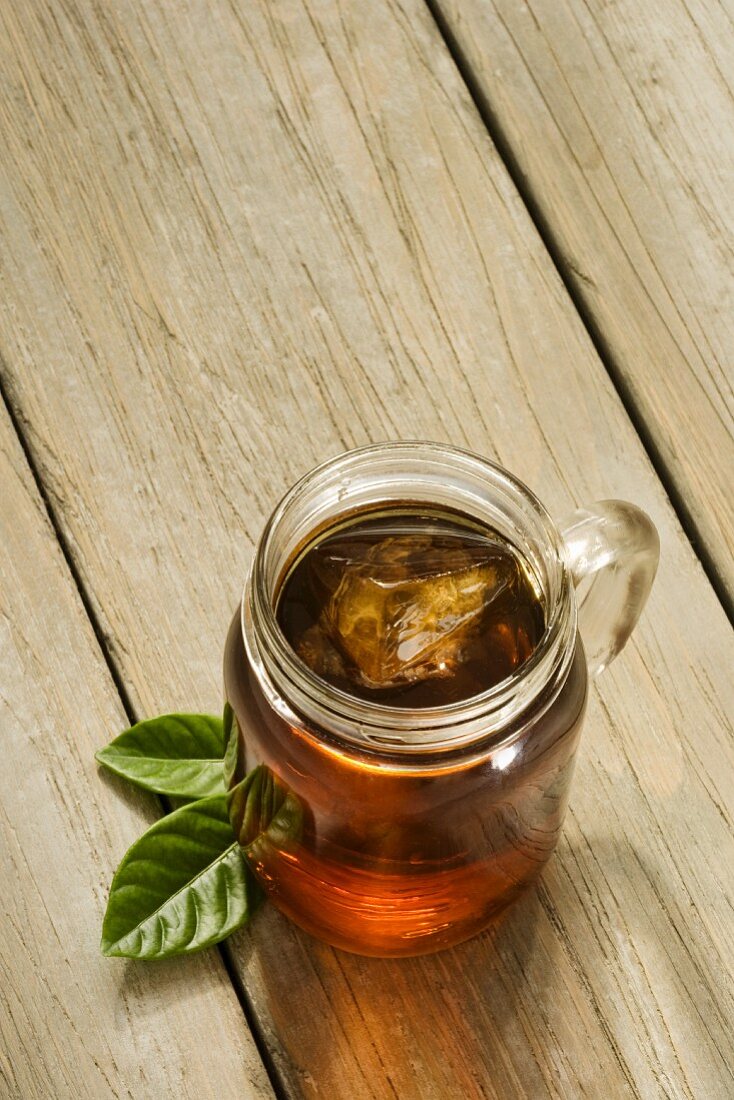Ice Tea in a Glass Mug with Ice Cube; Outdoors