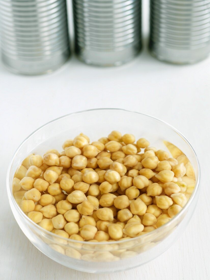 Bowl of Chickpeas Soaking in Water; Cans