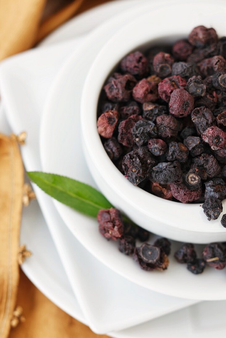 Dried Organic Blueberries in a White Bowl; From Above