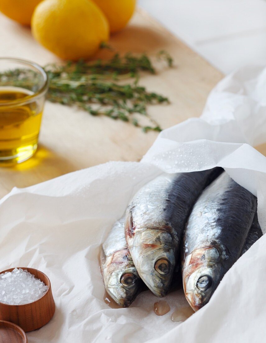 Fresh Sardines on Parchment Paper with Salt, Lemon and Herbs