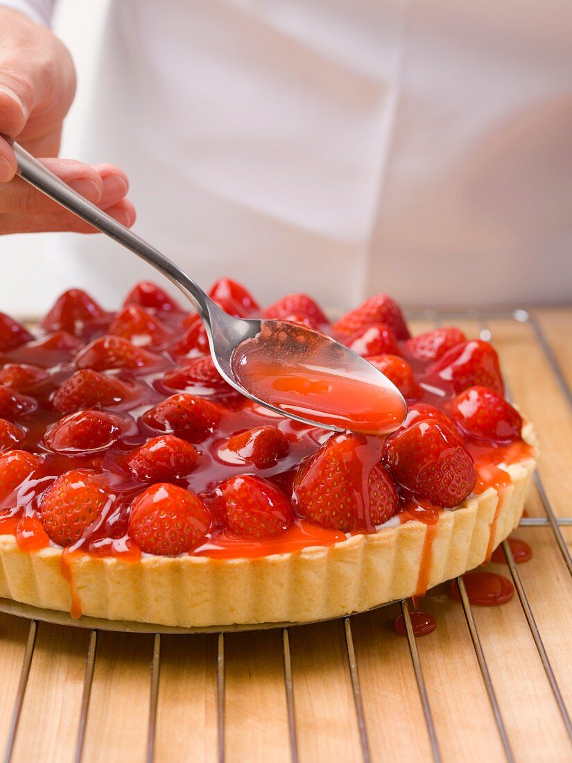 Glazing a strawberry tart