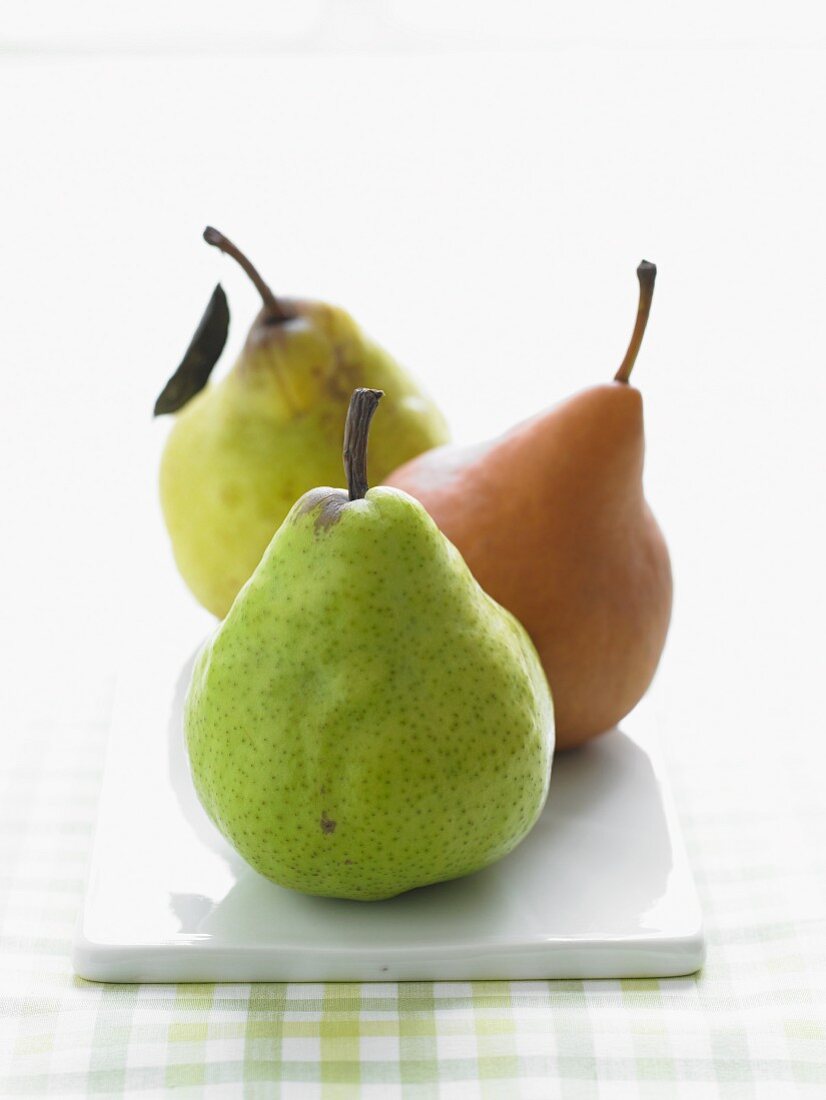 Three Assorted Pears in a Row on Rectangular Dish