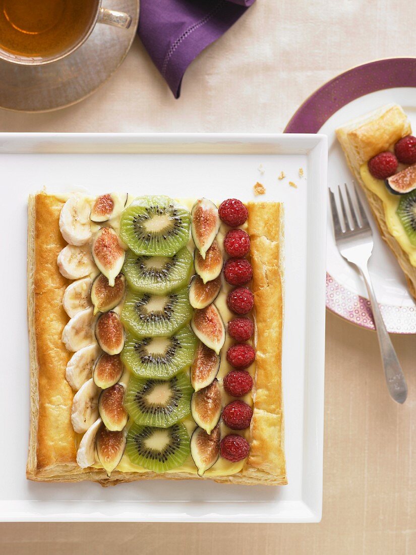 Winter Fruit Tart on a Platter; Slice on a Plate with a Fork
