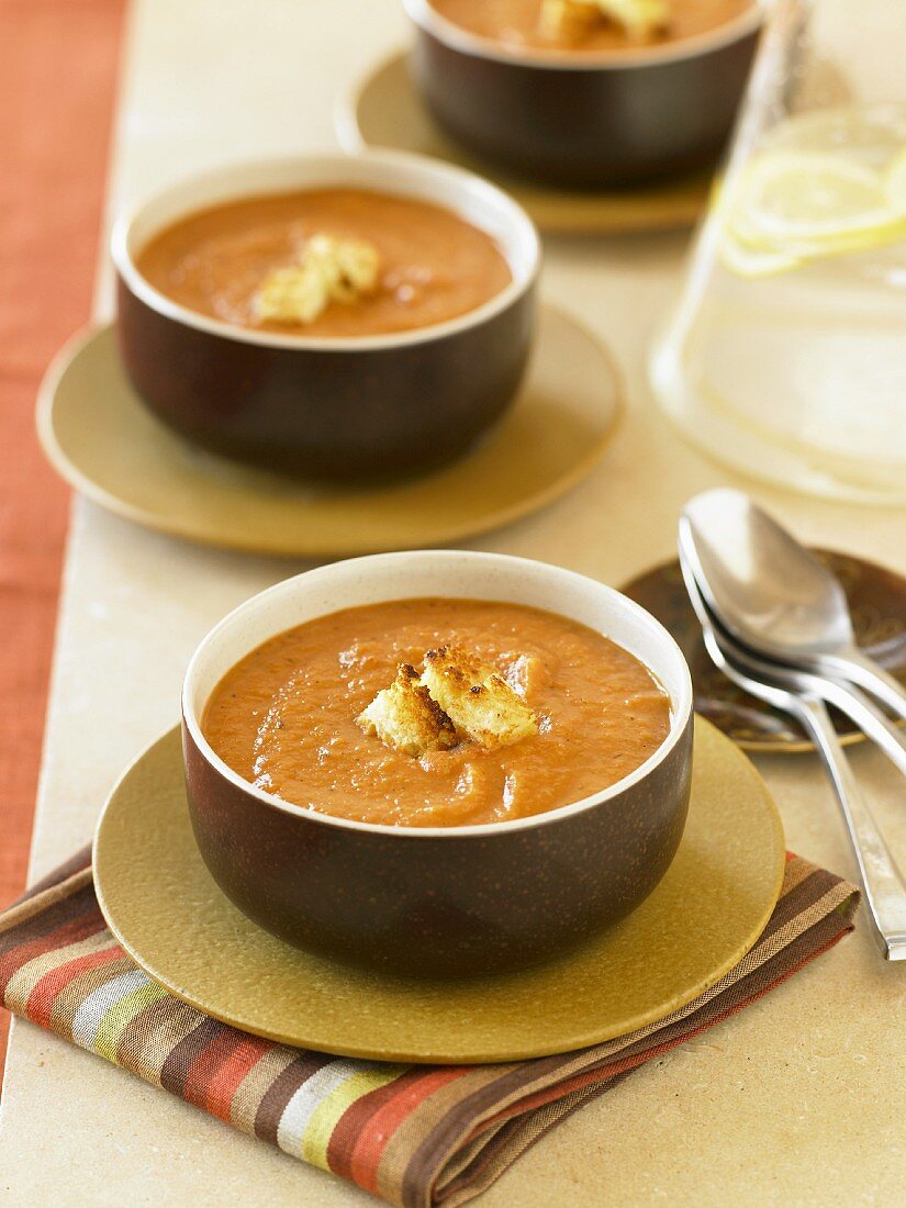 Bowls of Creamy Pumpkin Soup with Croutons