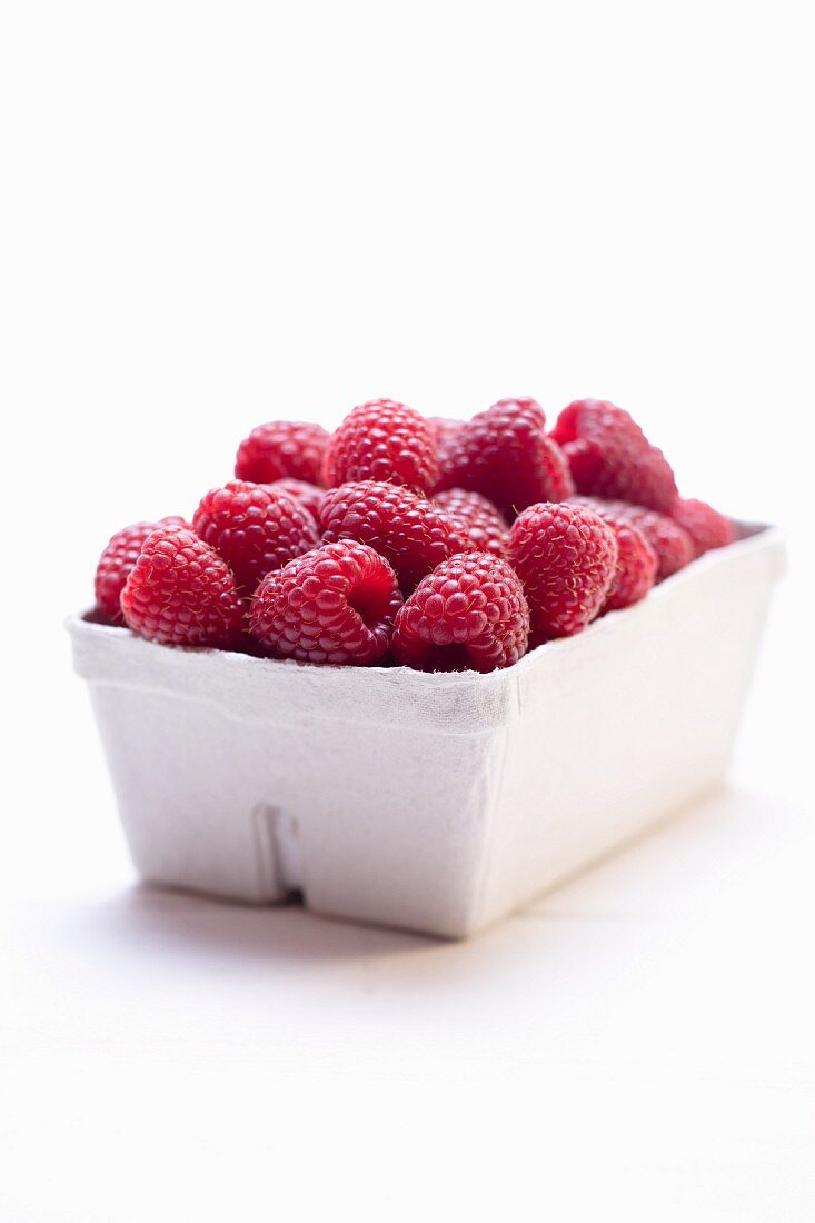 Raspberries in cardboard punnet