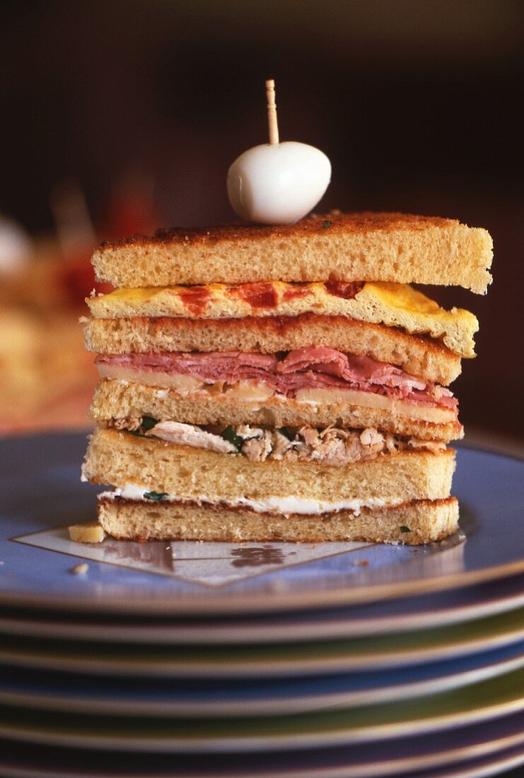 Club sandwich on stack of plates