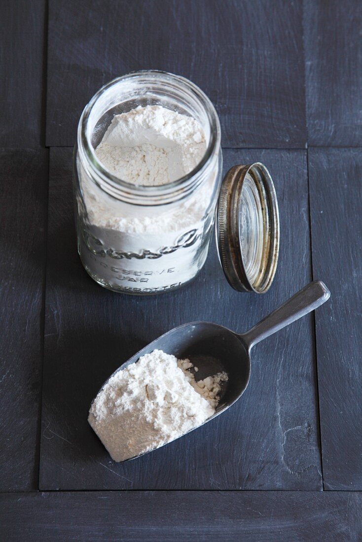 Flour in storage jar and on scoop