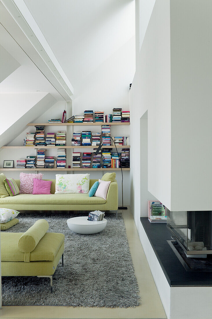 Attic living room with bookshelves and fireplace