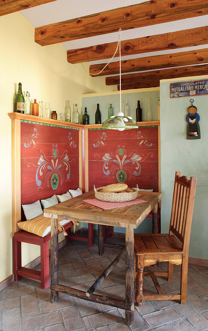 Bench and wooden table in the rustic dining area with pendant light