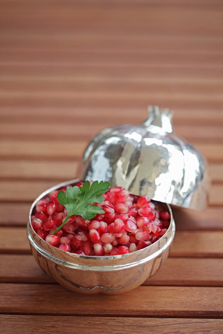 Pomegranate and onion salad in silver bowl